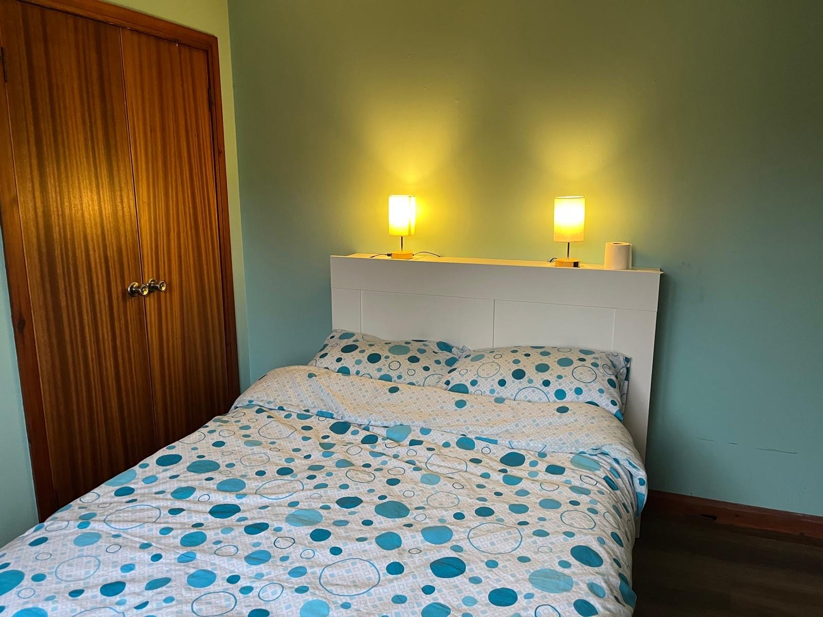 Main double bedroom at Barra Woodview — headboard with built-in reading lamps