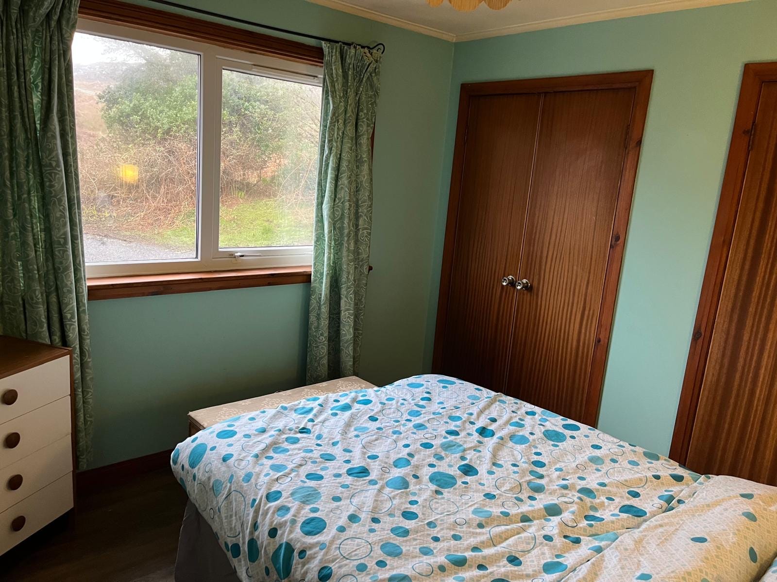 Main double bedroom at Barra Woodview — window with garden view and wardrobes