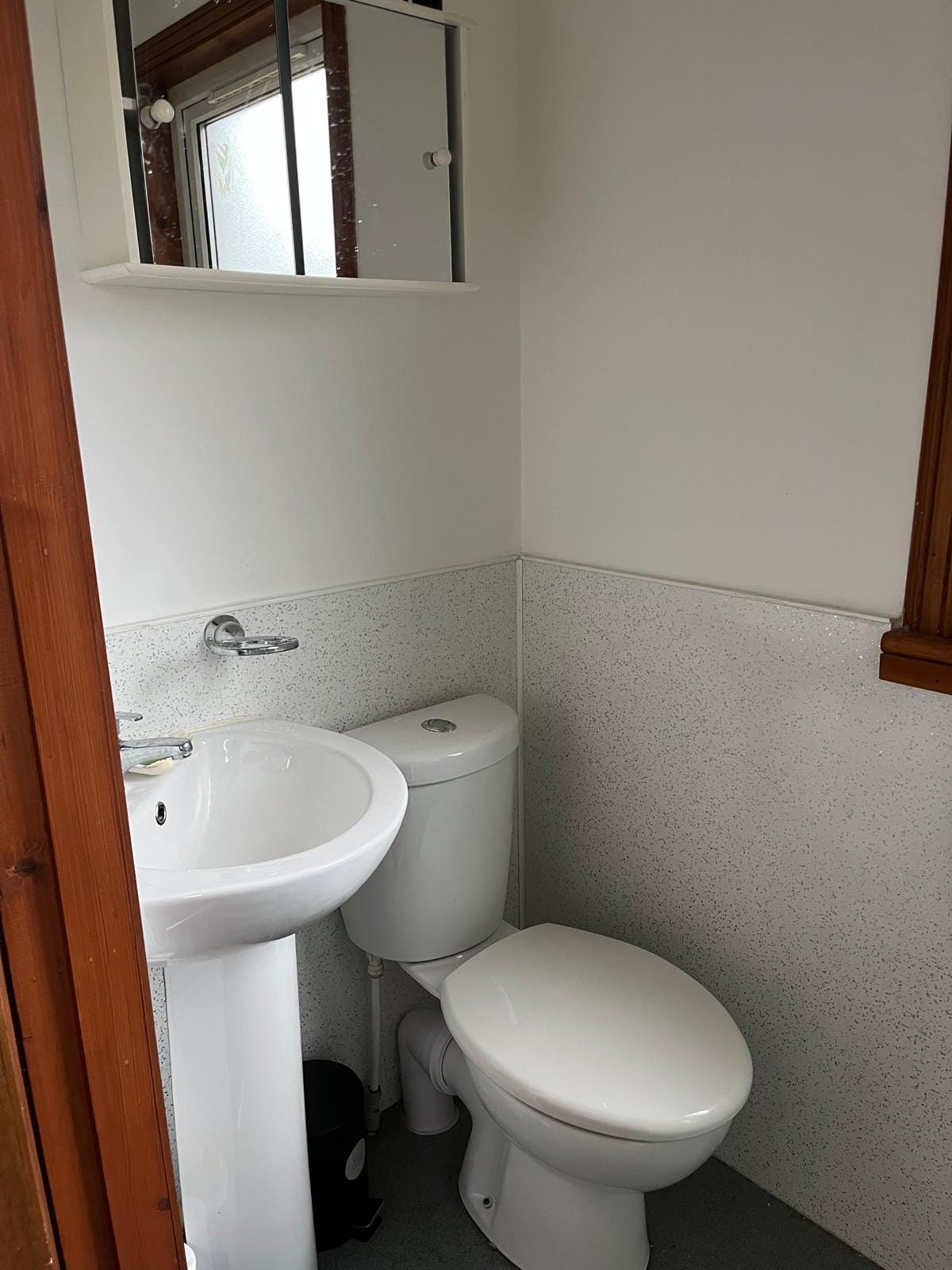 Porch shower room at Barra Woodview — WC and pedestal basin